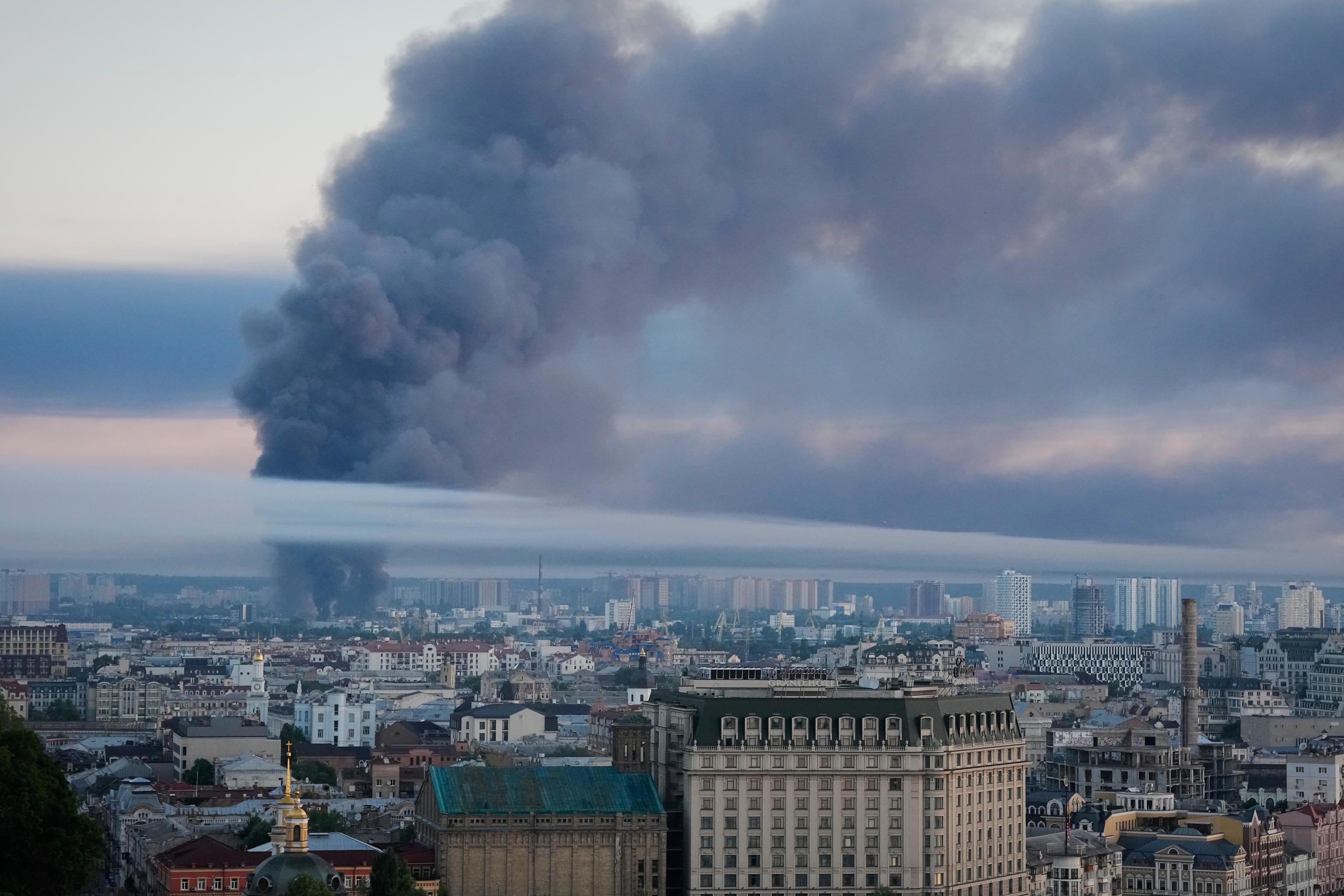 A column of smoke rises over Kyiv following a Russian attack.