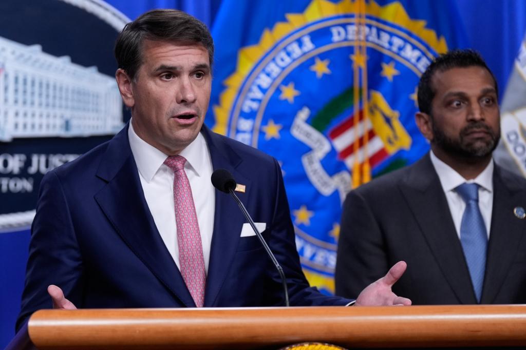 Acting Attorney General Todd Blanche speaks as FBI director Kash Patel listens
