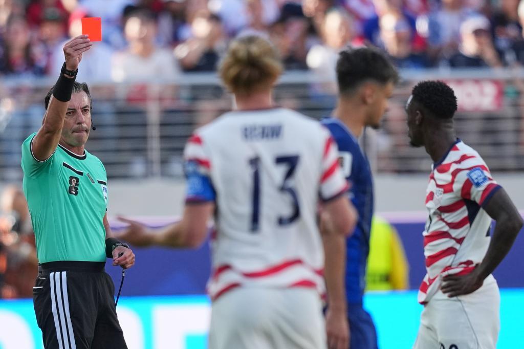 Brazilian referee Raphael Claus sends off Folarin Balogun (right), of the United States