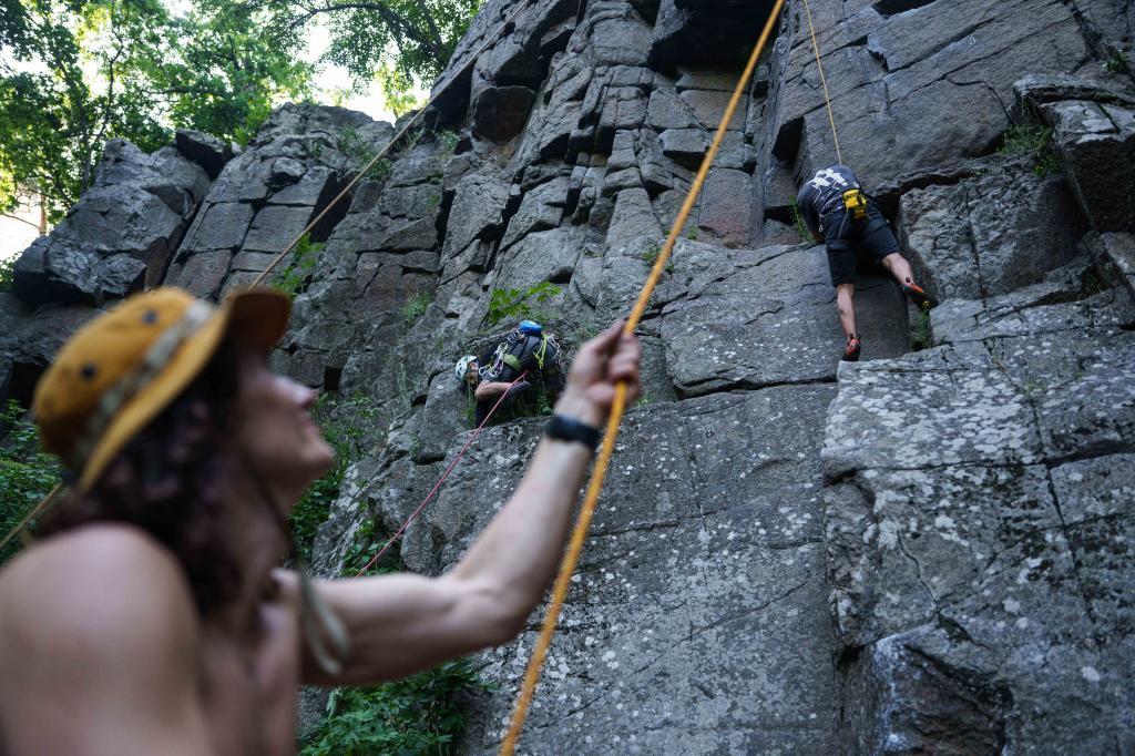 People climb on a cliff during the Stoned Climbers festival near Denyshi