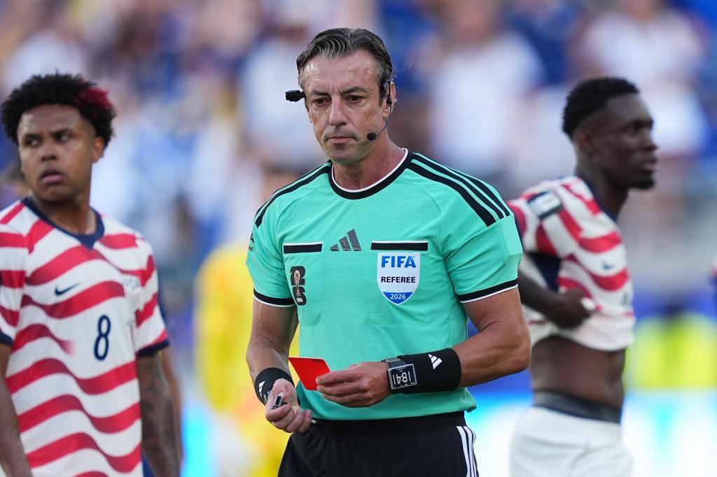 United States' Folarin Balogun, right, stands by after being issued a red card by Referee Raphael Claus