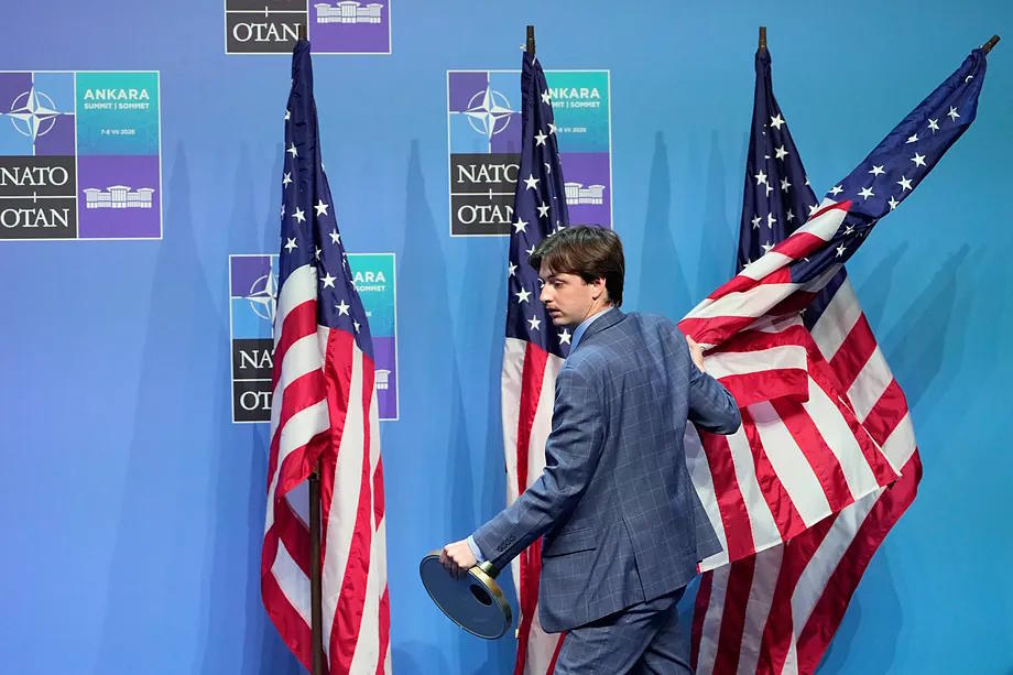 A member of the protocol service places US flags in Ankara.