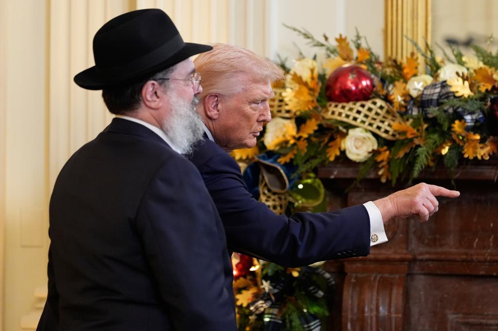 President Donald Trump gestures during a Hanukkah reception