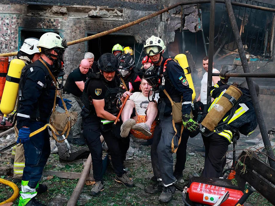 Rescue teams evacuate a resident after a Russian attack in Zaporiyia.