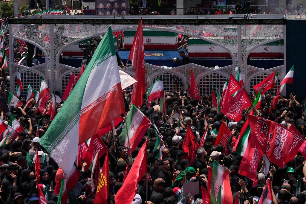 A truck, shown above, carrying the coffins of Iran's late Supreme Leader, Ayatollah Ali Khamenei, and members of his family