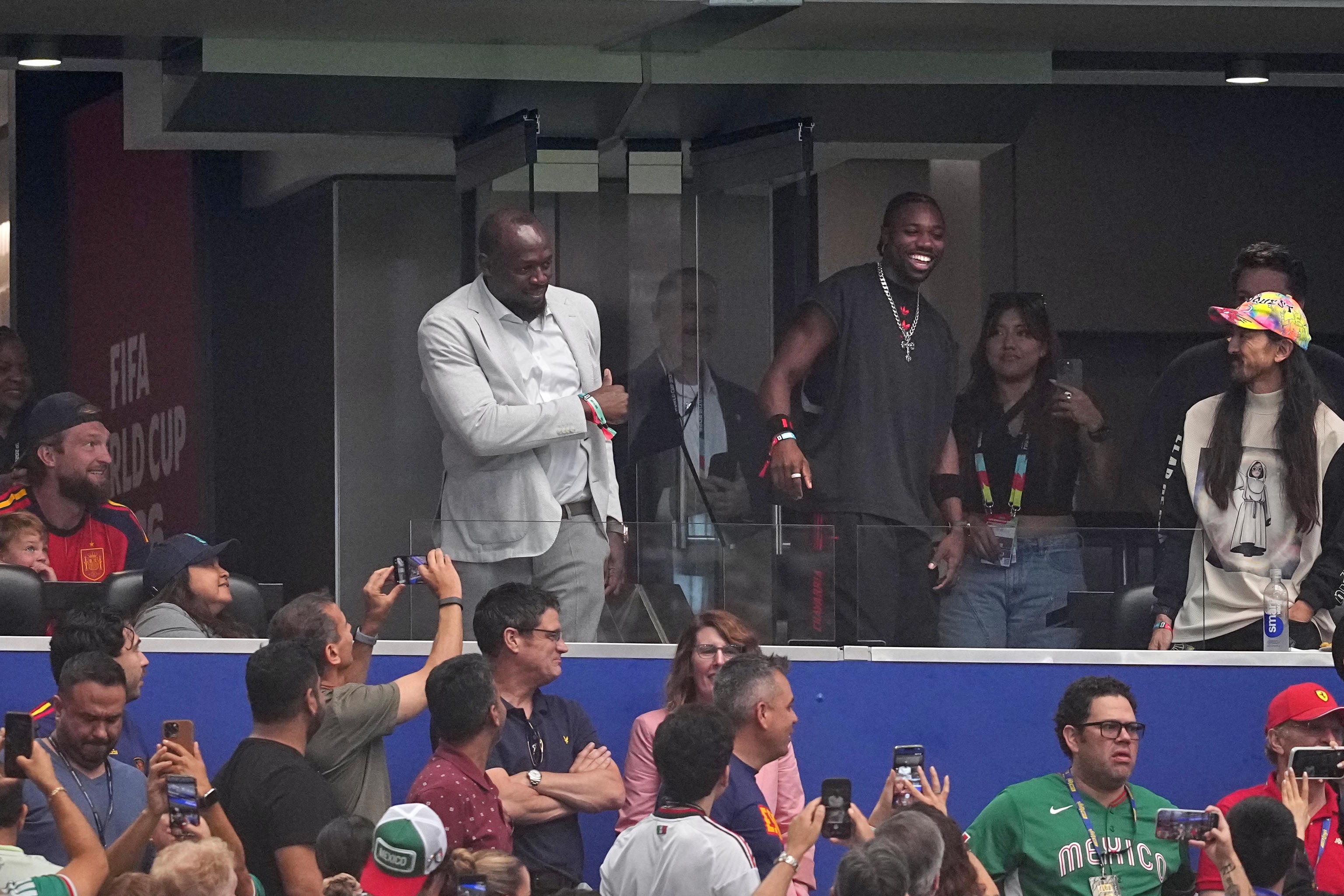 Jamaican sprint great Usain Bolt and US sprinter Noah Lyles greet fans.