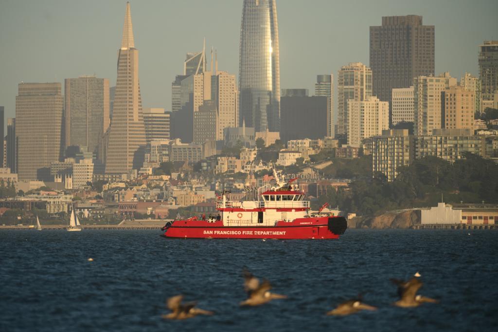 A San Francisco Fire Department vessel passes the city skyline while searching for missing victims