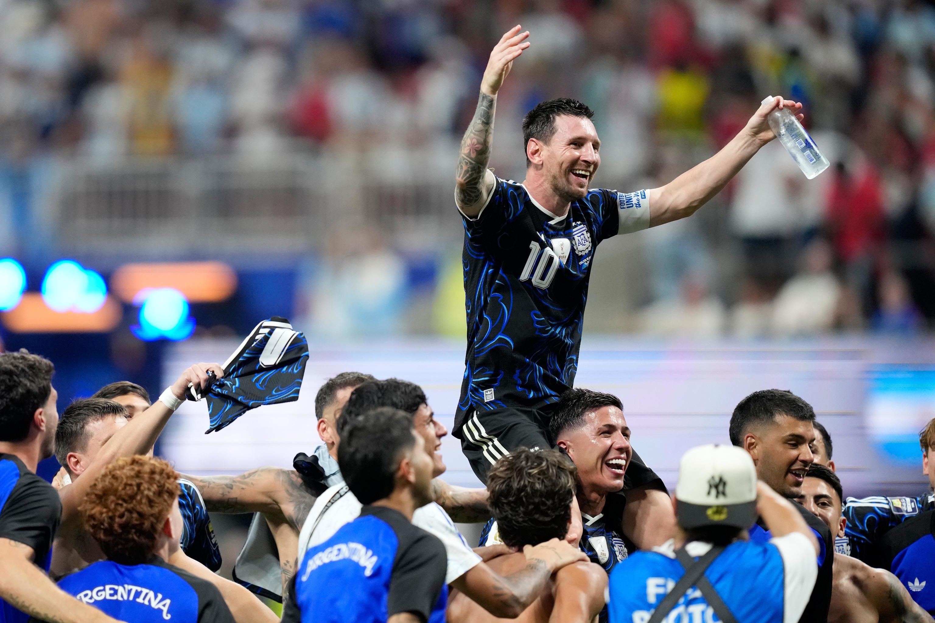 Messi is carried on his teammates' shoulders after the victory over England.