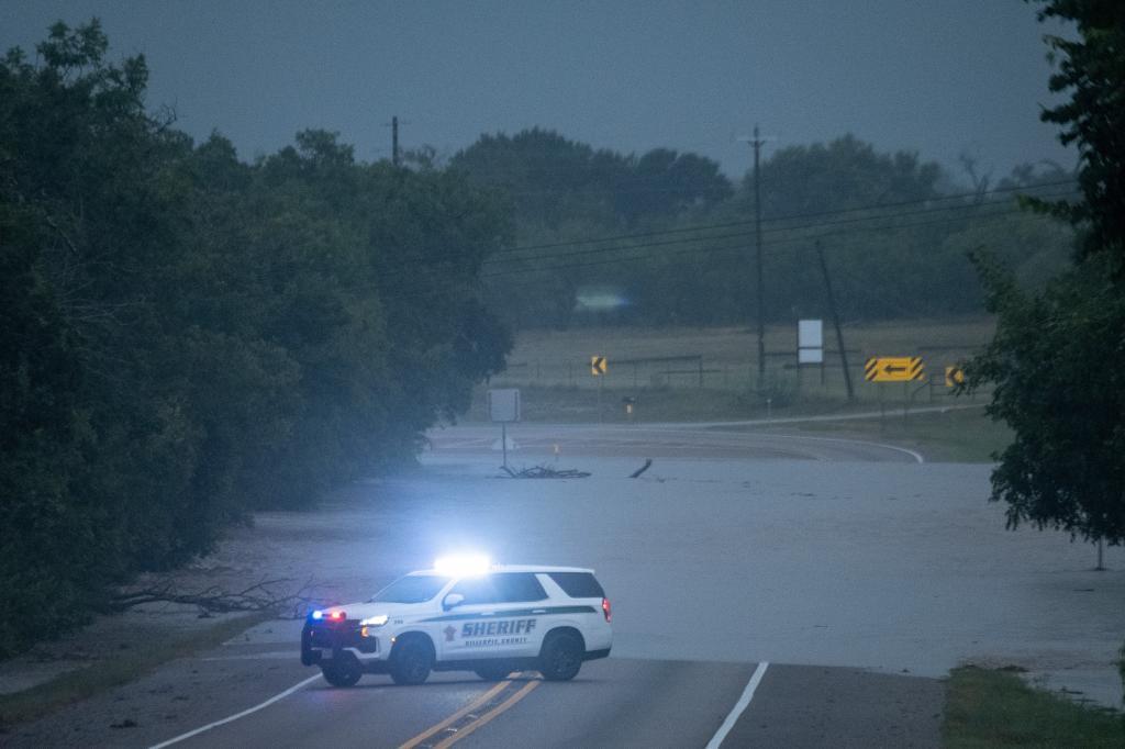 The Pedernales River floods along State Highway 16