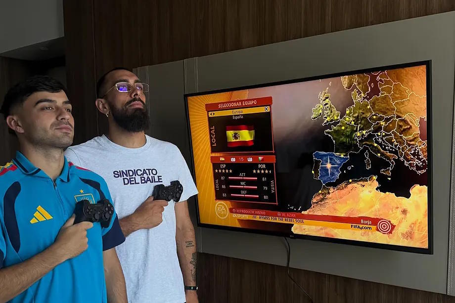Pedri and Borja Iglesias, playing the 2010 World Cup video game.