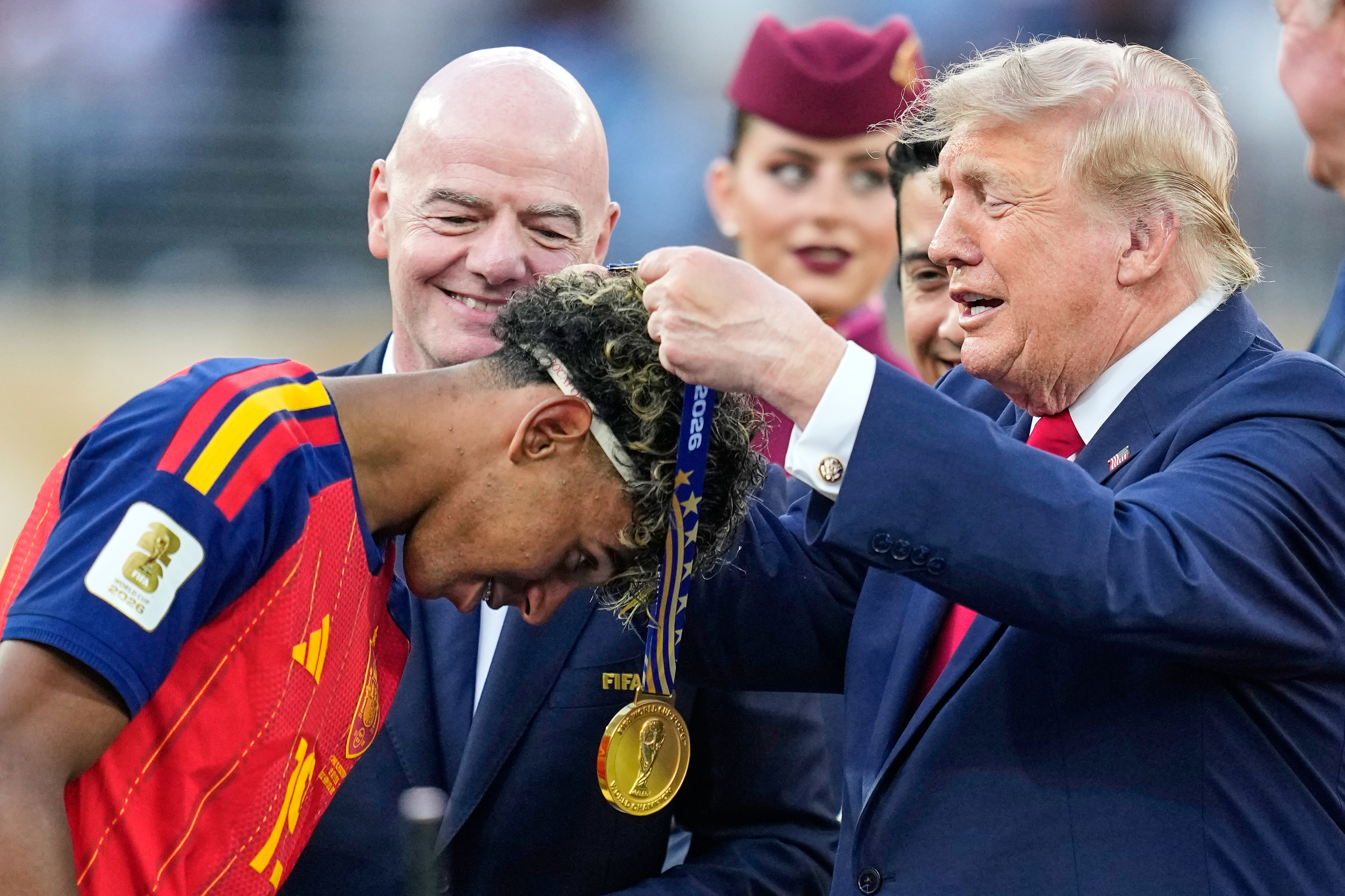 Spain's Lamine Yamal (19) receives his winners medal from President Donald J. Trump.