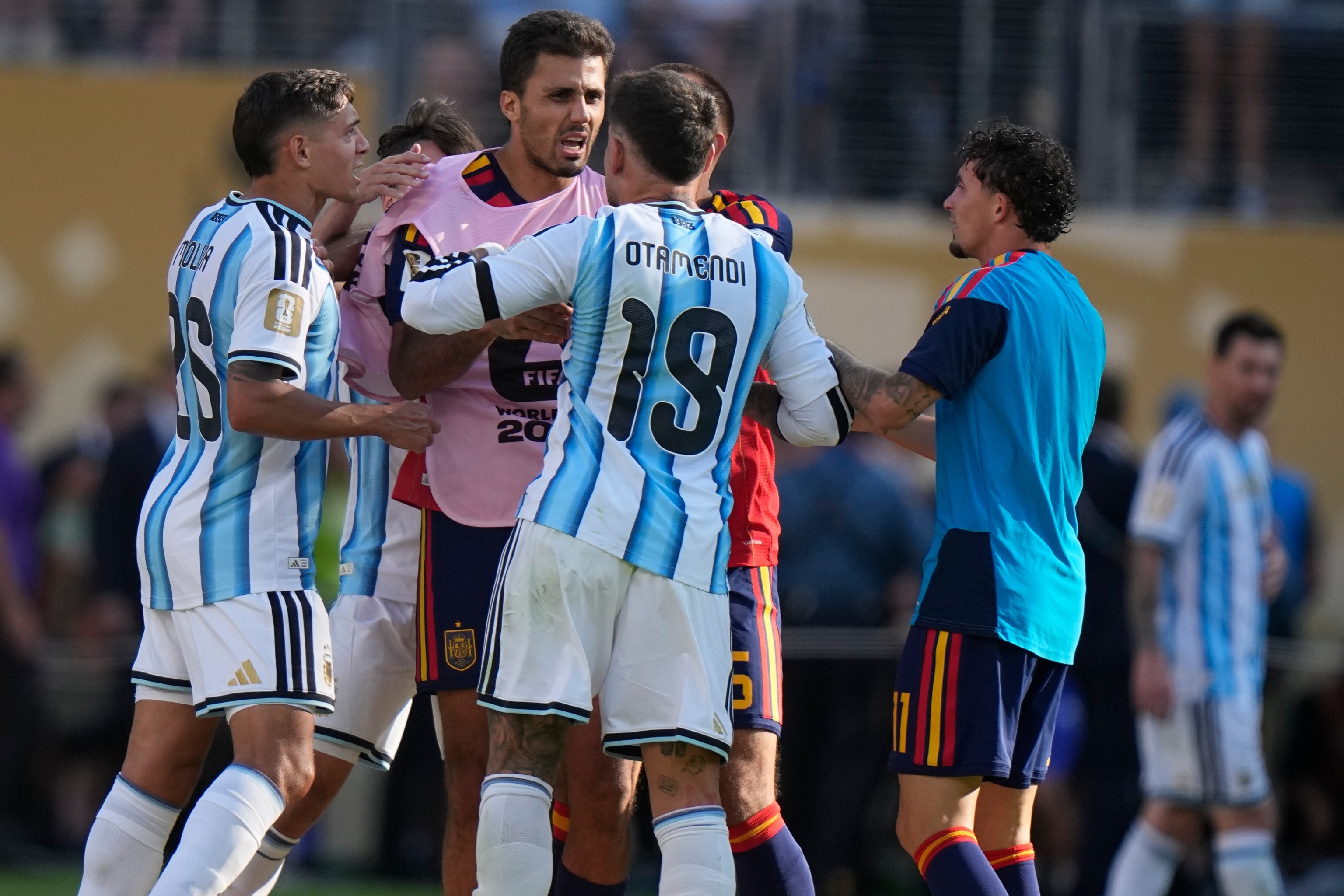 Argentina's Nicolas Otamendi and Nahuel Molina scuffle with Spain's Rodri.