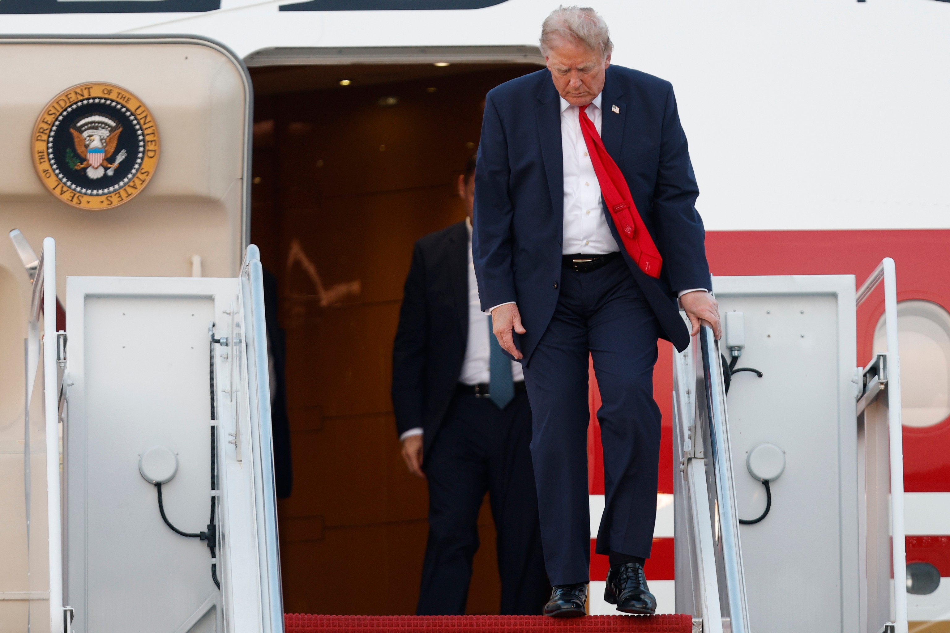 President Donald Trump walks down the stairs of Air Force One.