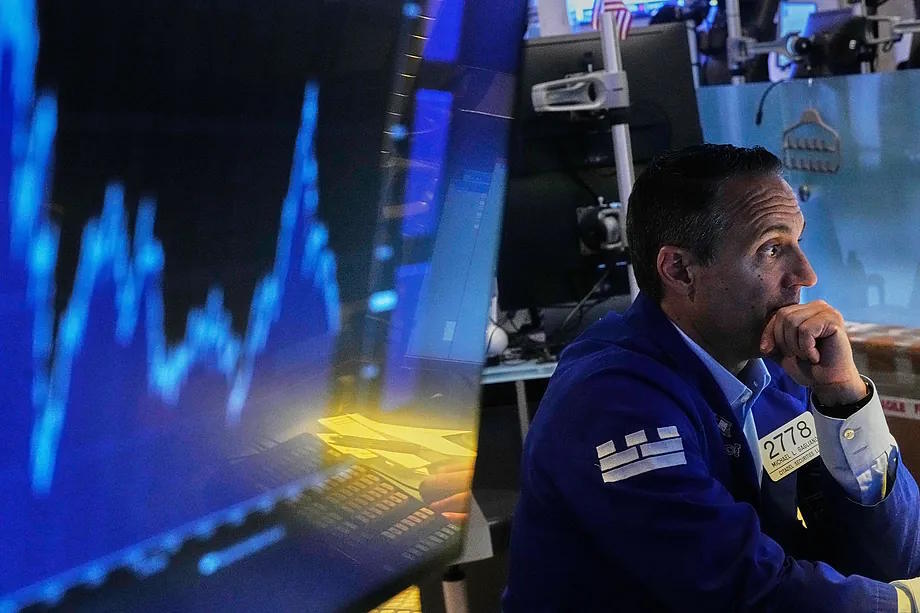 Broker Michael Gagliano works at his desk at the New York Stock Exchange on June 25.