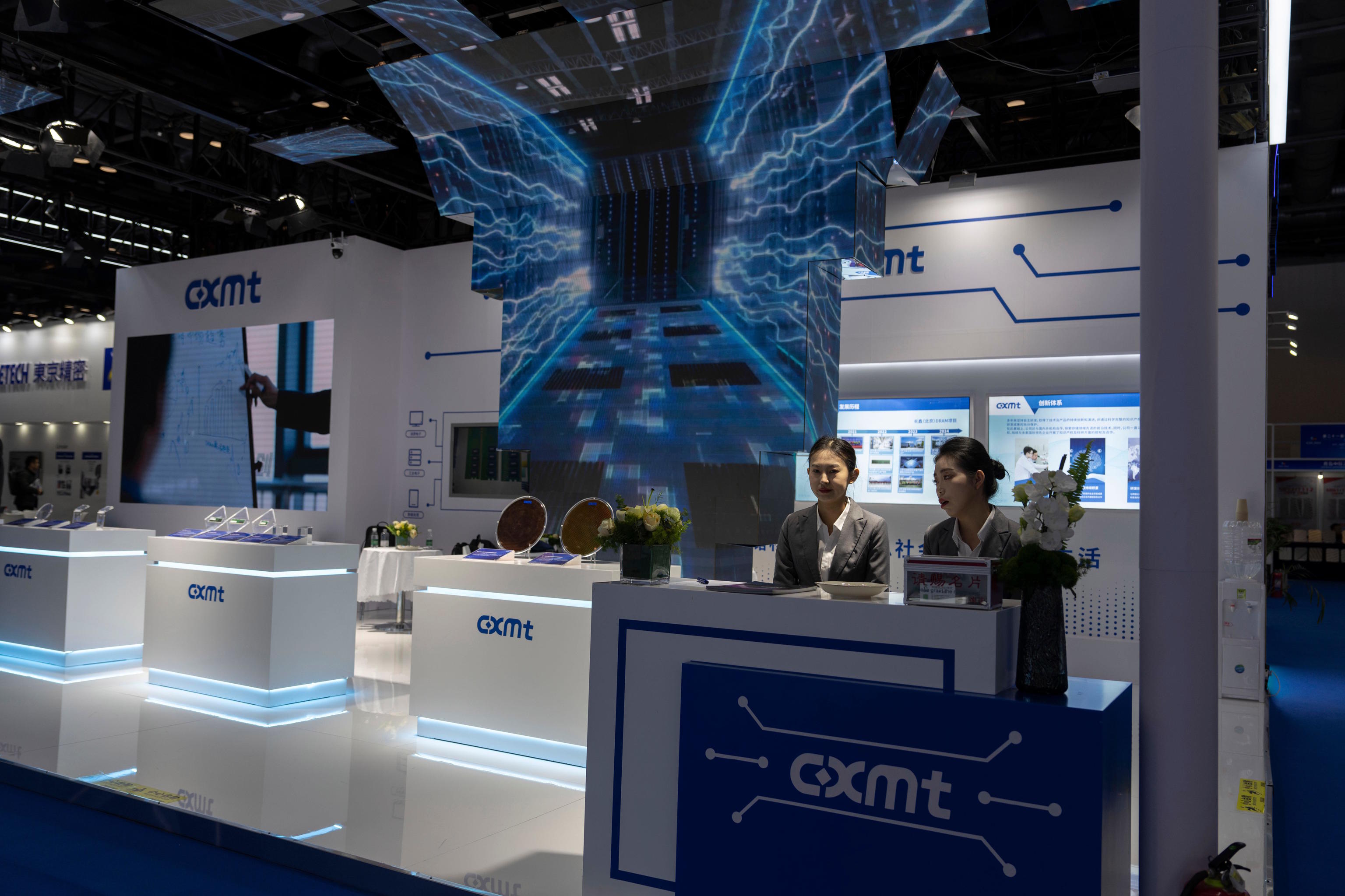 Workers at the booth for Chinese DRAM producer ChangXin Memory Technologies.