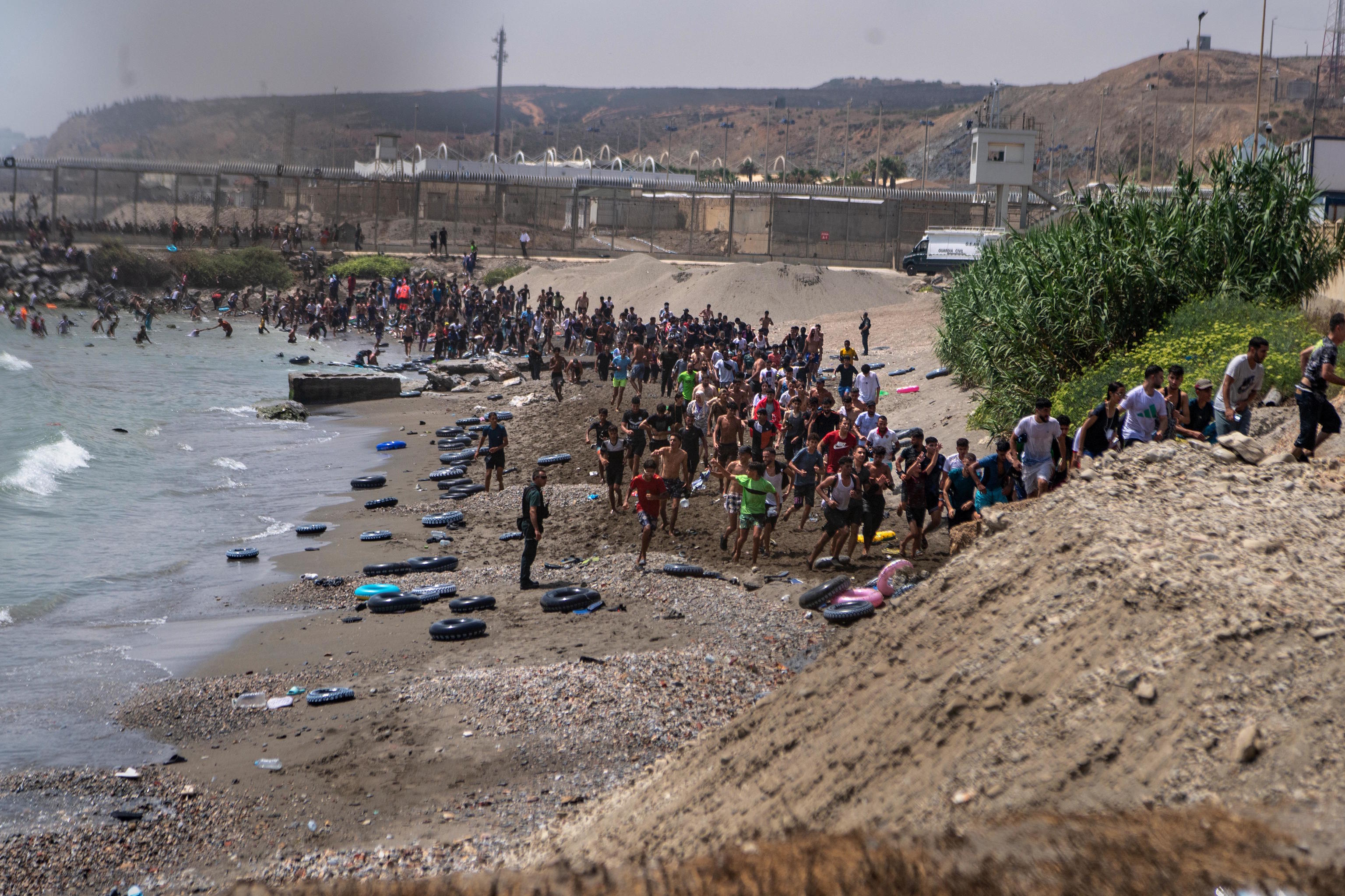 Migrants cross from Morocco into the Spanish enclave of Ceuta on Thursday, July 30, 2026.