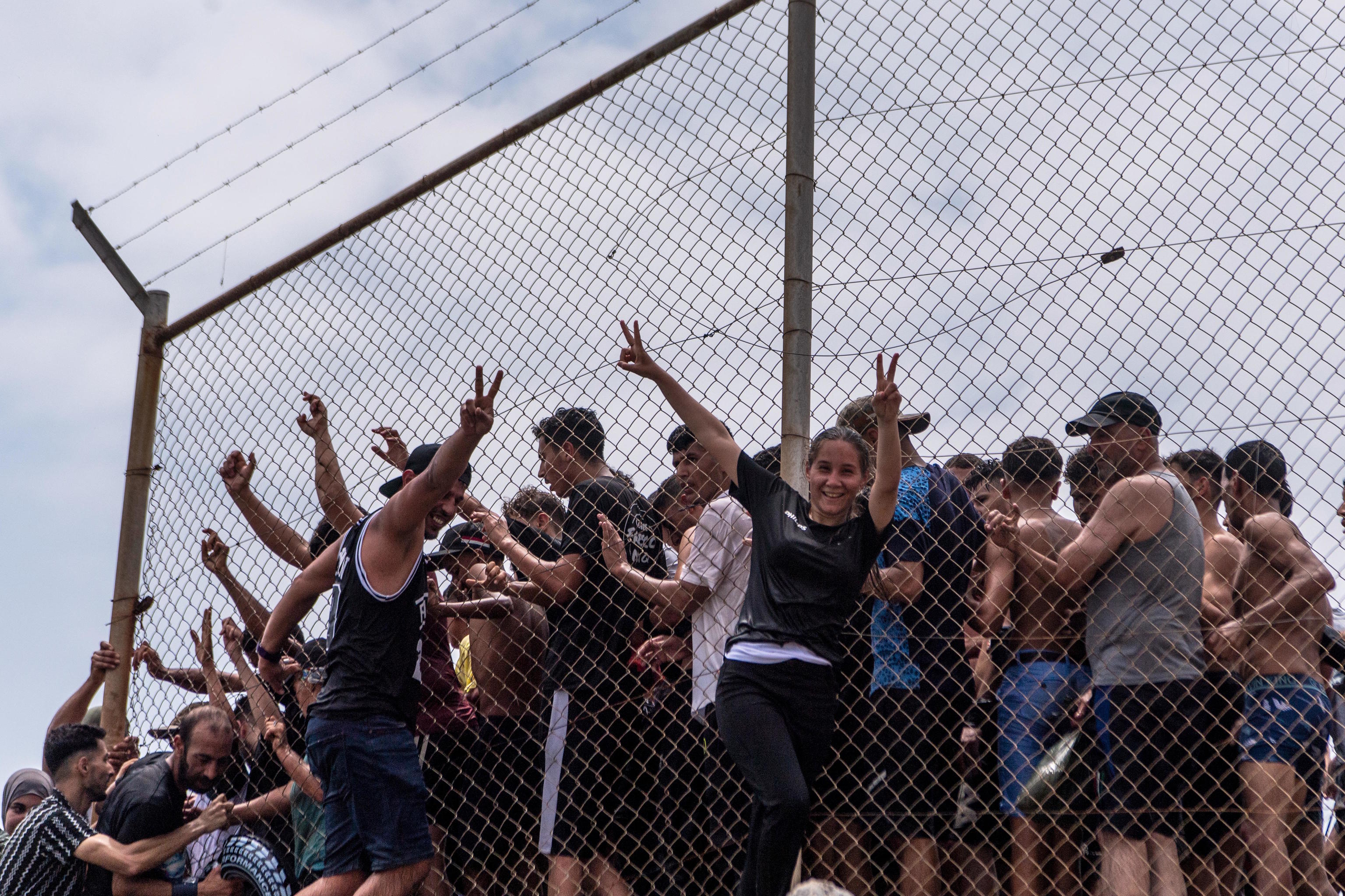 Migrants cross from Morocco into the Spanish enclave of Ceuta on Thursday, July 30.