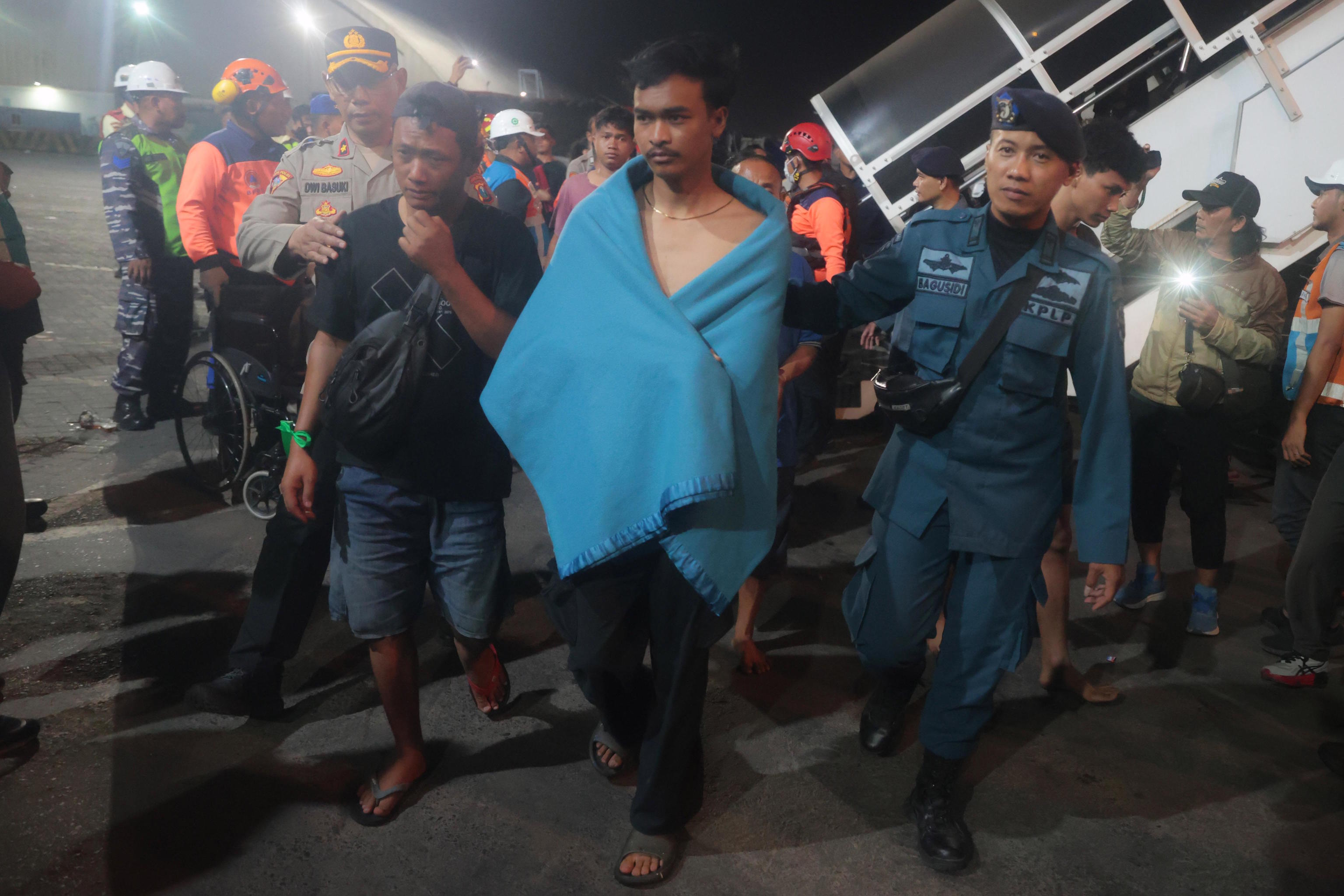 Survivors of a ferry fire arrive at Tanjung Perak Port in Surabaya, East Java.