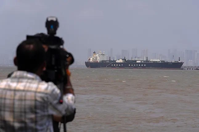 A cameraman films the Indian-flagged LPG Jag Vasant tanker at the Port of Mumbai.