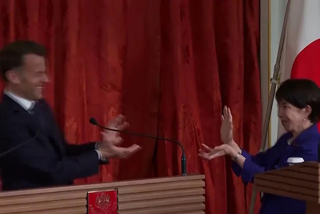 Japan's Prime Minister, Takaichi, makes the Dragon Ball gesture during her meeting with Macron.