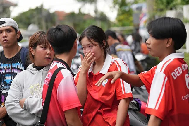 A student cries outside the educational center.