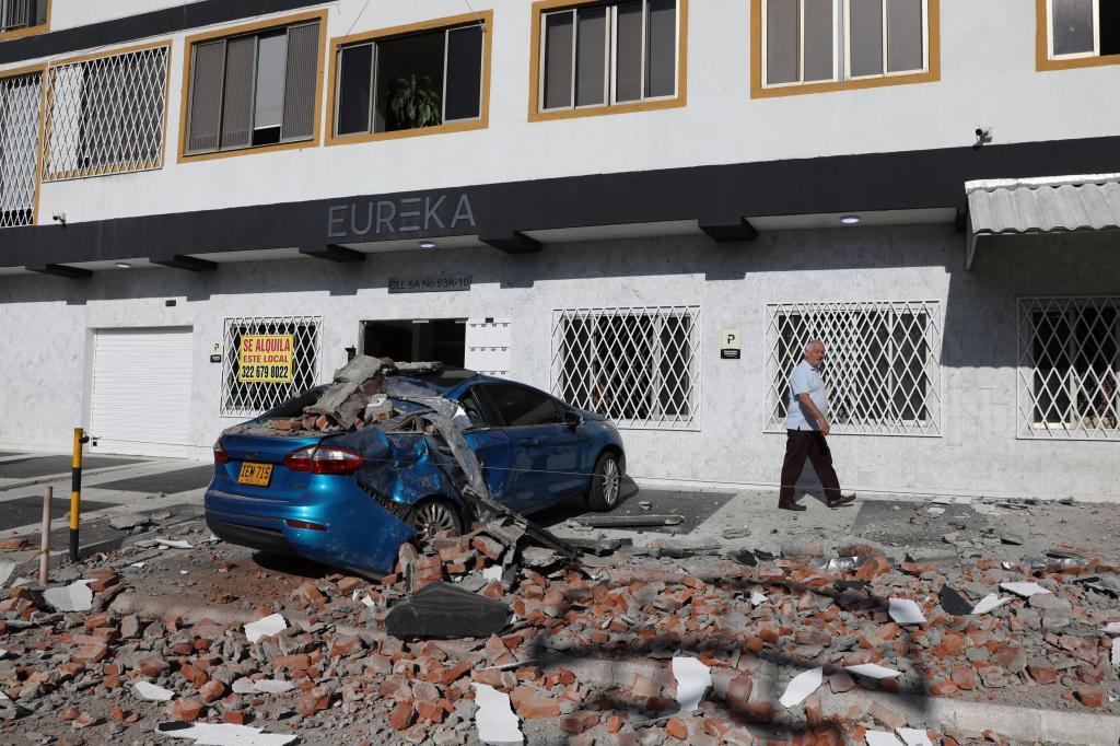 Debris covers a car after an earthquake struck Cali