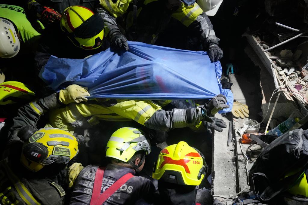 Rescue workers pull a survivor Daniela Largo from the rubble the day after an earthquake