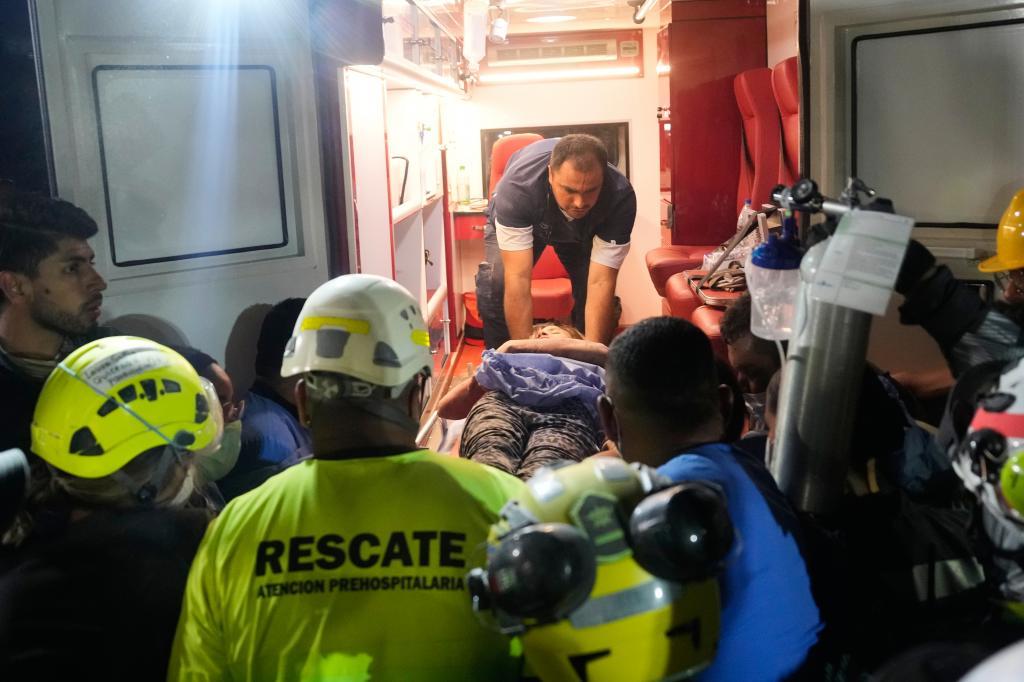 Rescue workers carry a survivor Daniela Largo.
