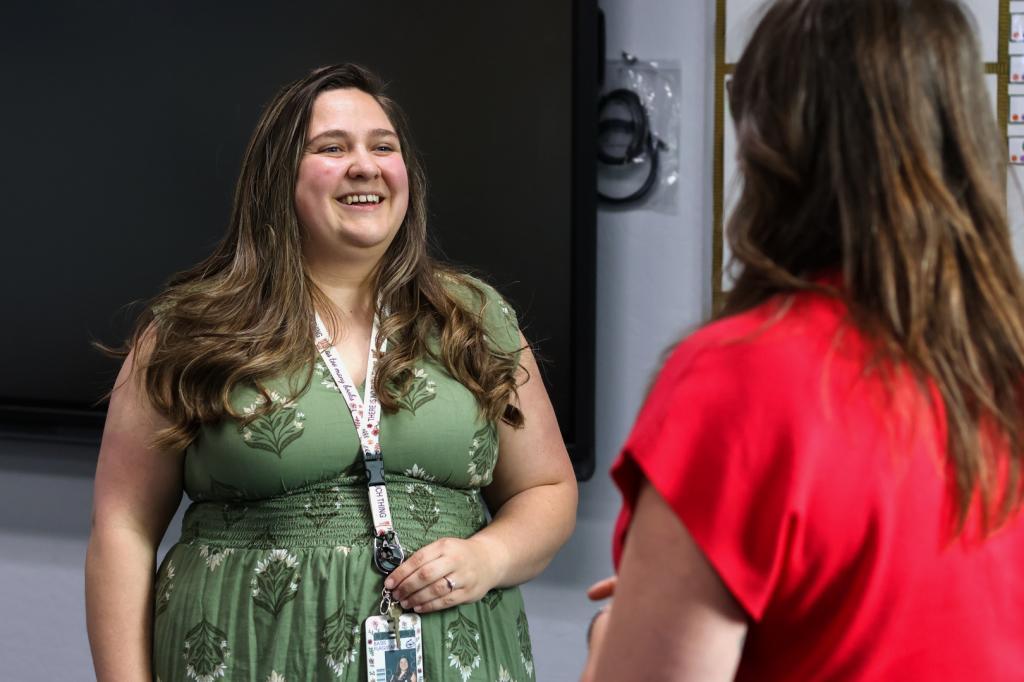 Elementary school teacher Emily Henderson speaks with the high school guidance counselor about back-to-school planning