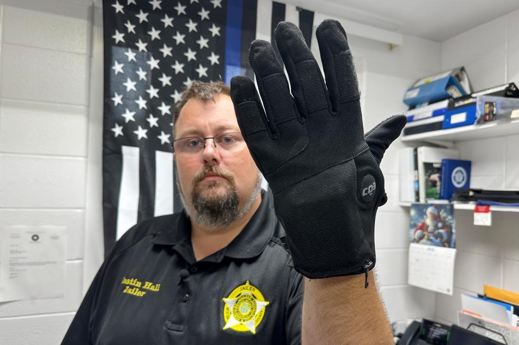 Nelson County, Ky., jailer Justin Hall shows an electric shock glove