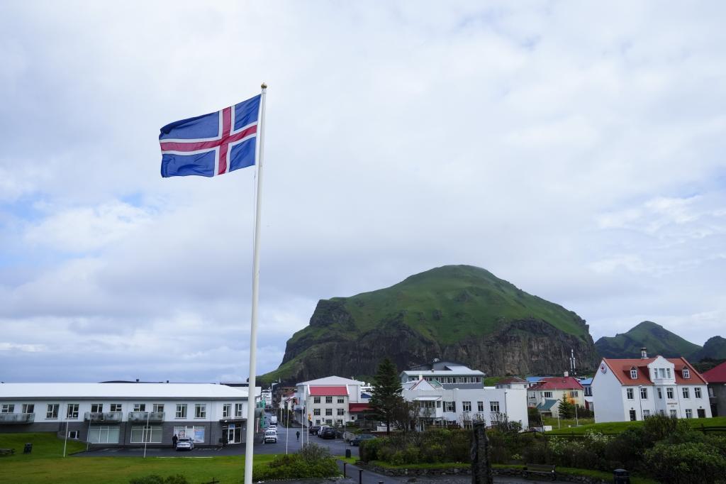 The Icelandic flag flies in Vestmannaeyjar, Iceland