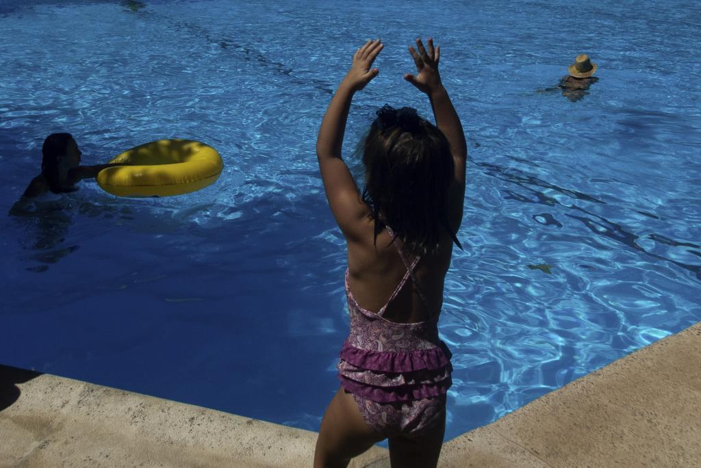 Some people playing in the pool.