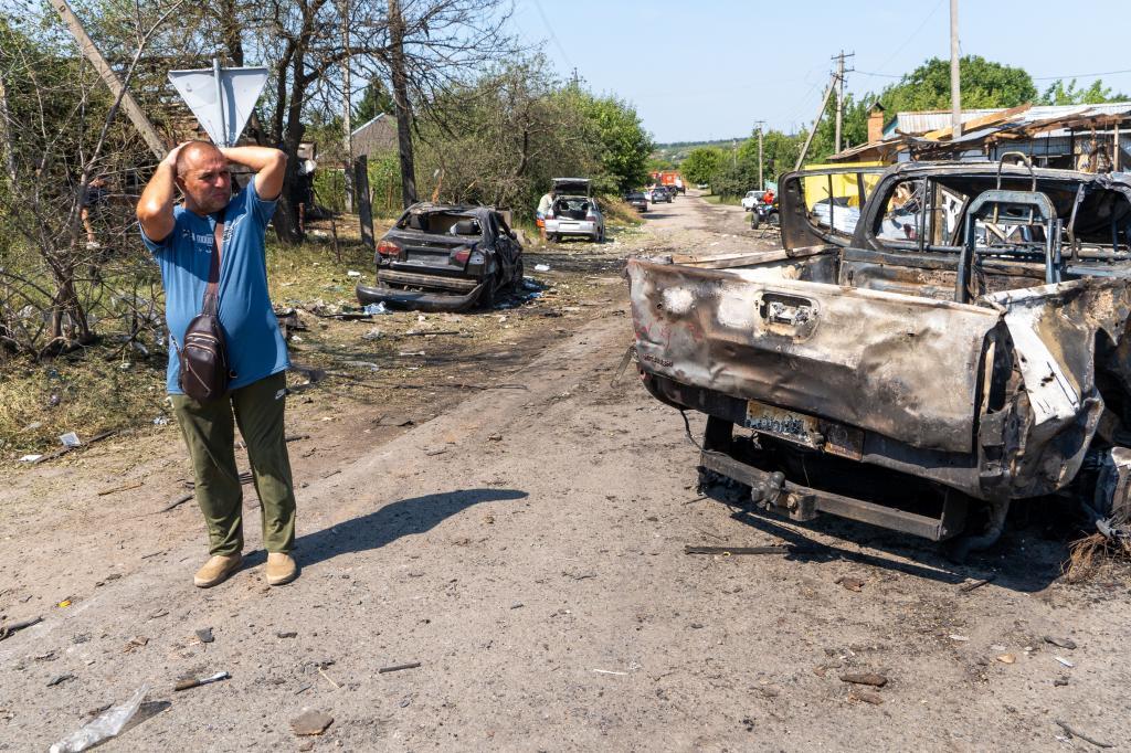 A local resident reacts as he looks at ruins following a Russian air attack which killed at least ten civilians in Pechenihy