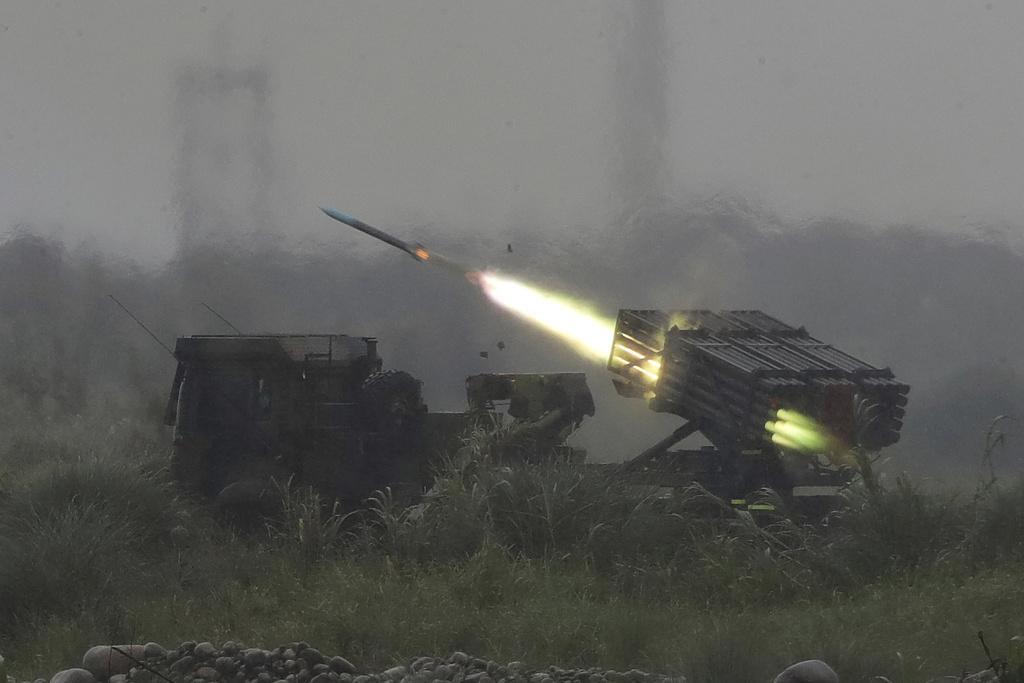 A rocket is fired from a multi-rocket launcher during a military live-fire shooting training in Taichung City