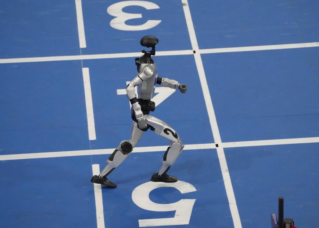 A robot competes in the 100m obstacles final during the World Humanoid Robot Games