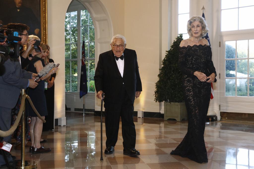 Former Secretary of State Henry Kissinger, left, and wife Nancy Kissinger