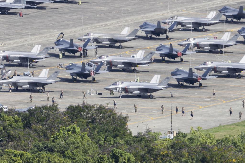 U.S. F-35 fighter jets are parked on the tarmac as military personnel walk among the aircraft at Jos� Aponte de la Torre Airport in Ceiba, Puerto Rico