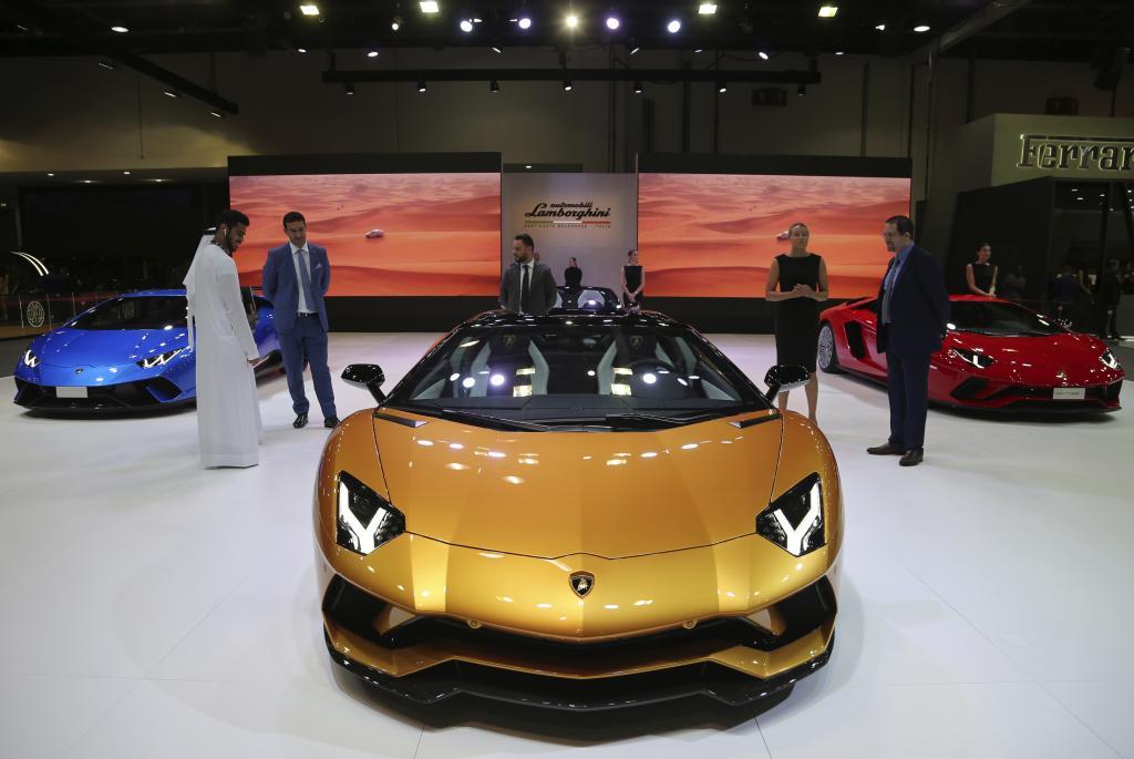 People visit the Lamborghini stand at the Dubai Motor Show in the United Arab Emirates