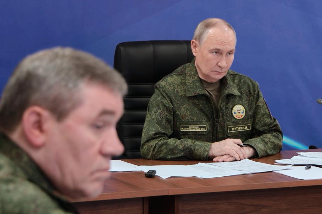 Russian President Vladimir Putin speaks as he visits one of the command posts of the Joint Group of the Russian Forces as Russian Chief of General Staff Gen. Valery Gerasimov
