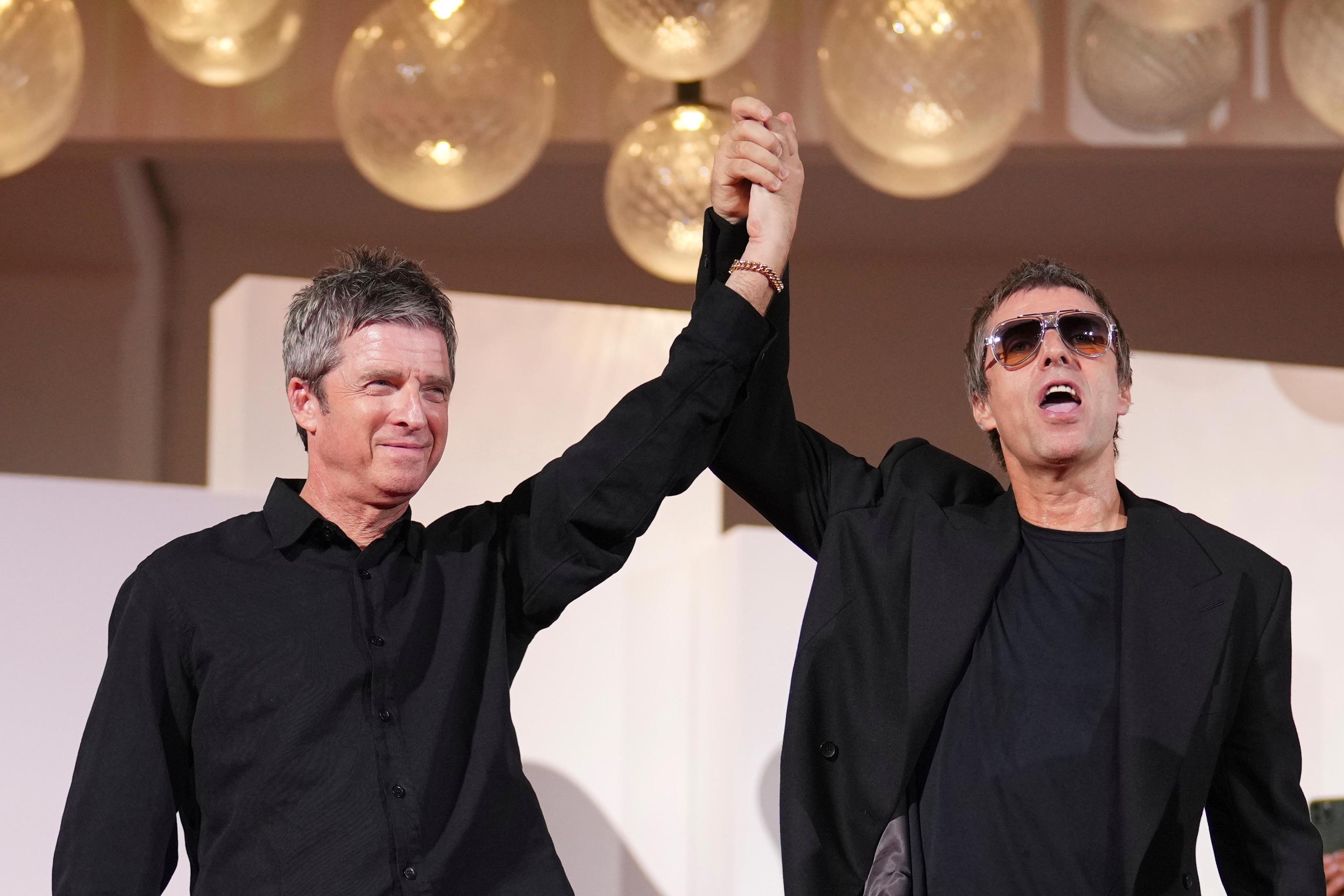 Noel Gallagher, left, and Liam Gallagher pose for photographers at the red carpet.