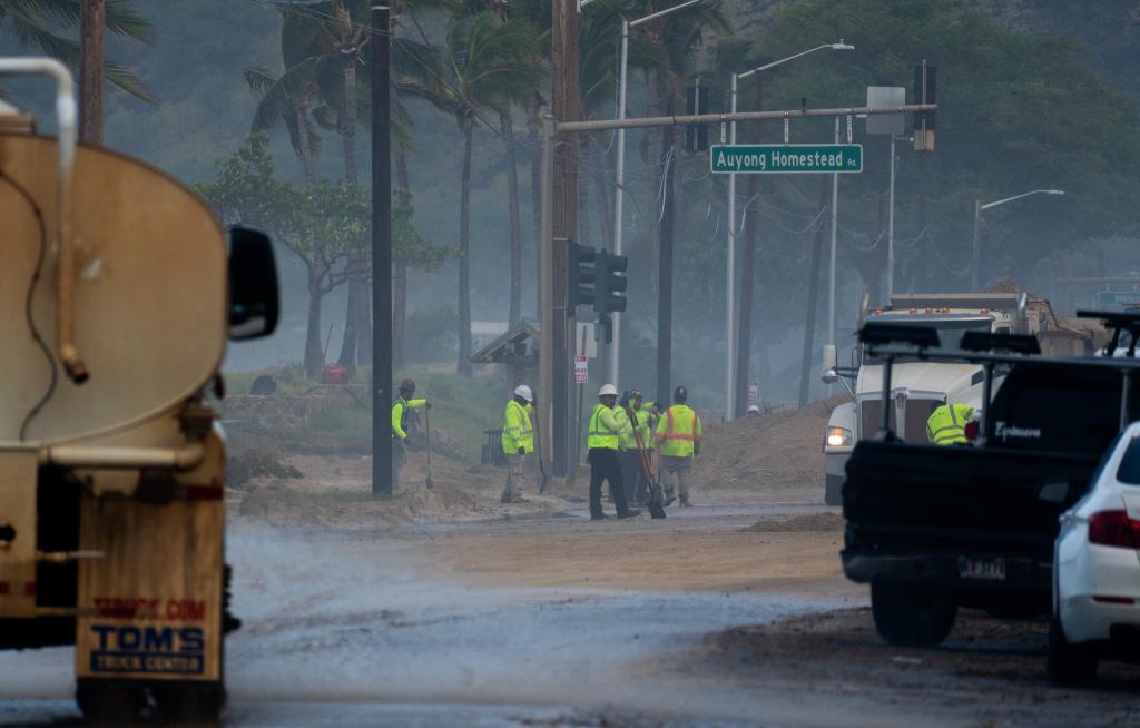A work crew helps to clean up after damage caused by Hurricane Lowell