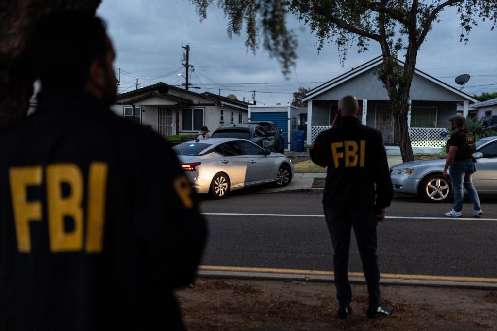 FBI agents stand outside the home of Lakiya Malone