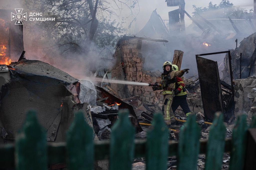 firefighters put out a fire at private homes following a Russian air attack in Sumy