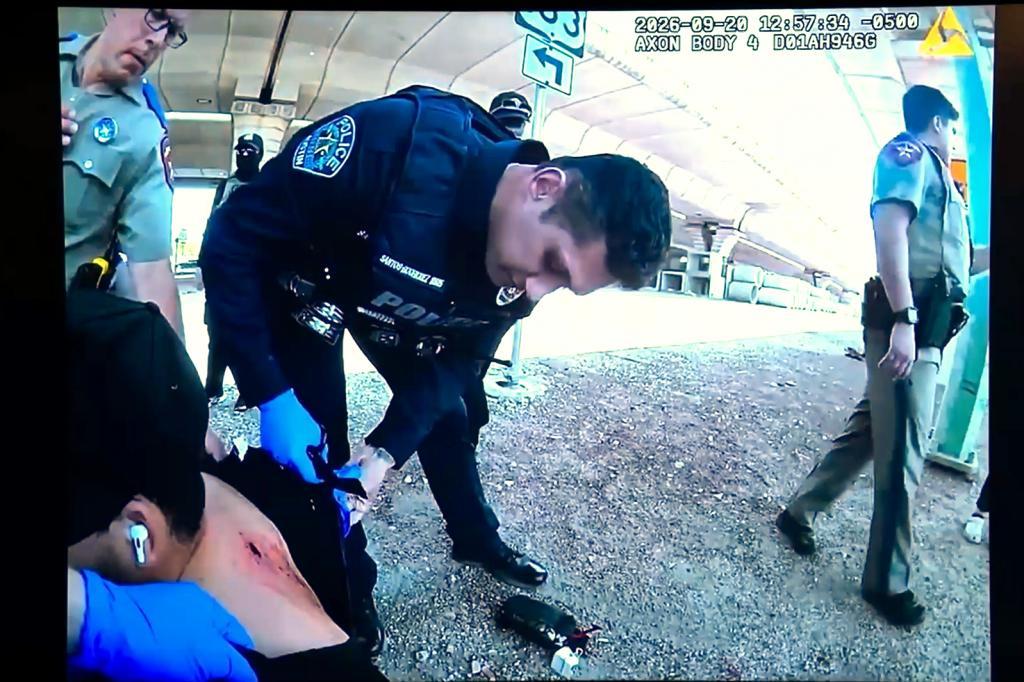 Officers inspect Wilber Rafael Garces Perez's wound after he was shot by a U.S. Immigration and Customs Enforcement agent
