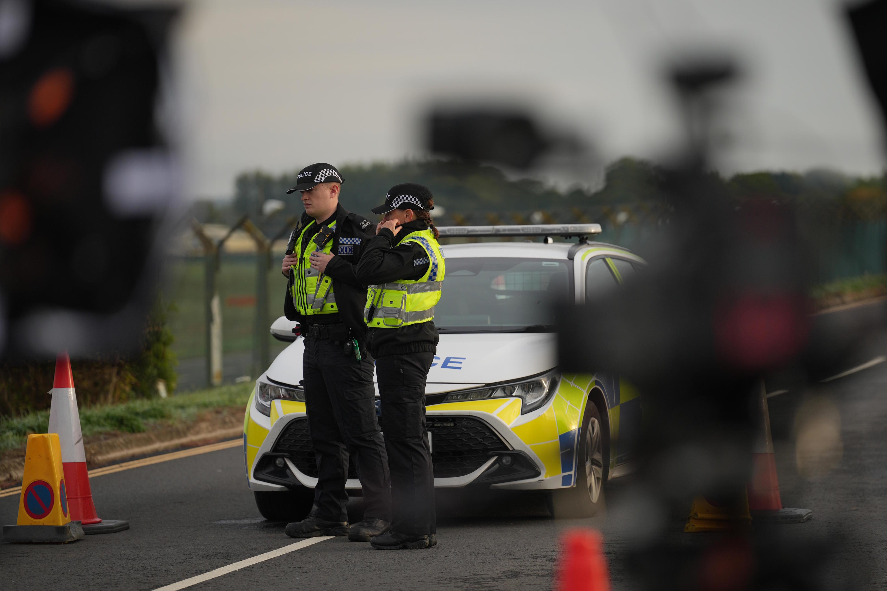 Police officers guard a road leading to RAF Fairford.