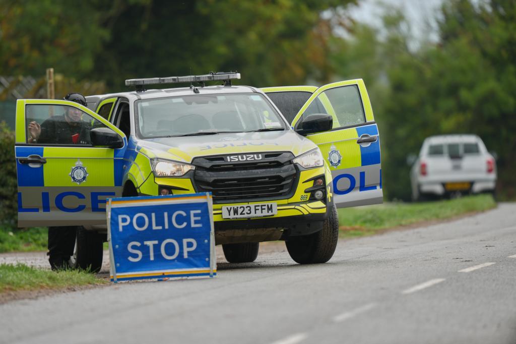 Police guard a road leading to RAF Fairford, a US Airbase, after an incident in Fairford
