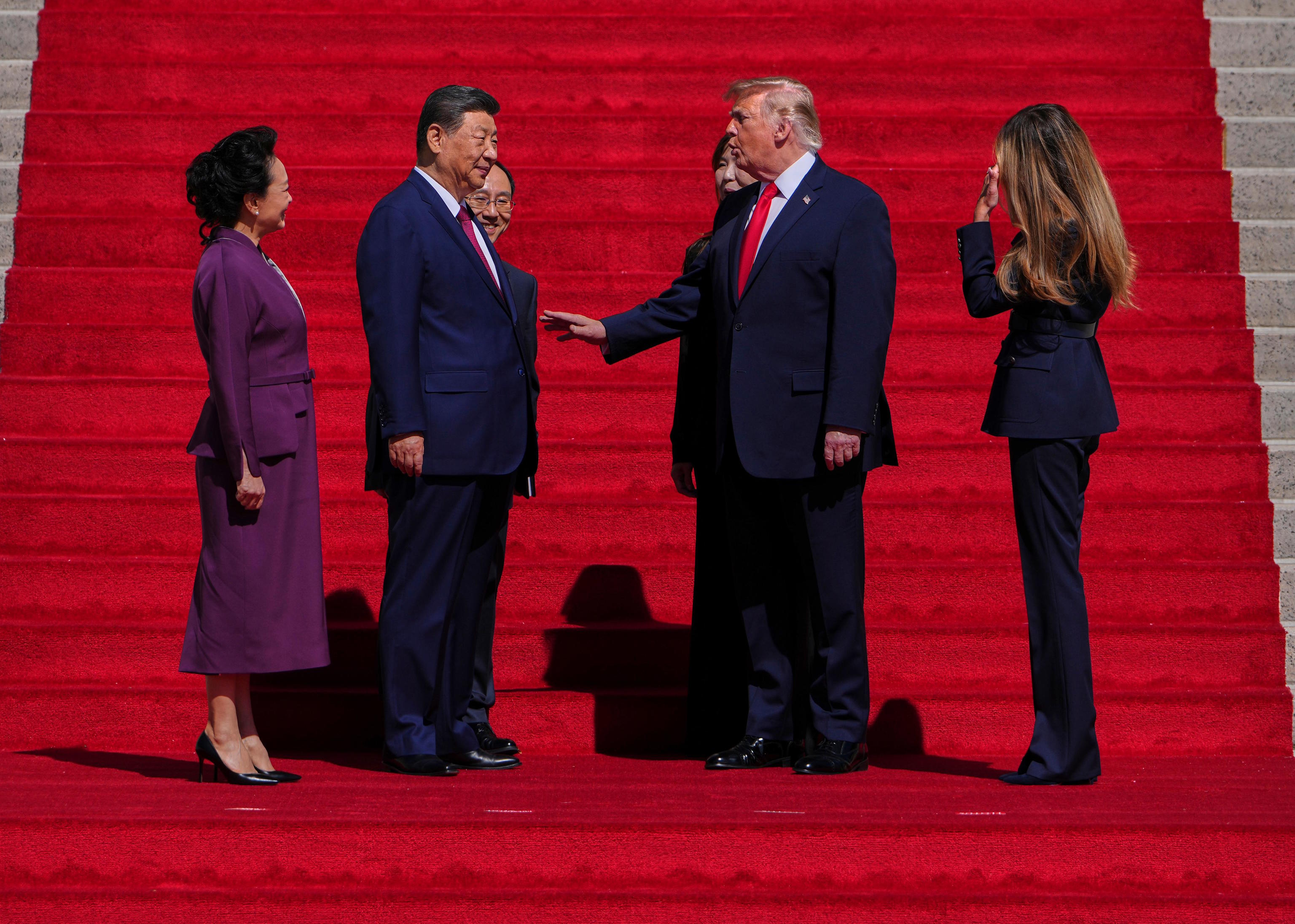 President Trump and first lady Melania speak with China's President Xi Jinping and his wife Peng Liyuan.