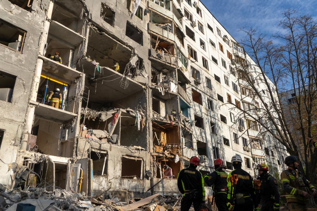 Rescue workers clear the rubble from a residential house damaged in a Russian strike on Kharkiv,