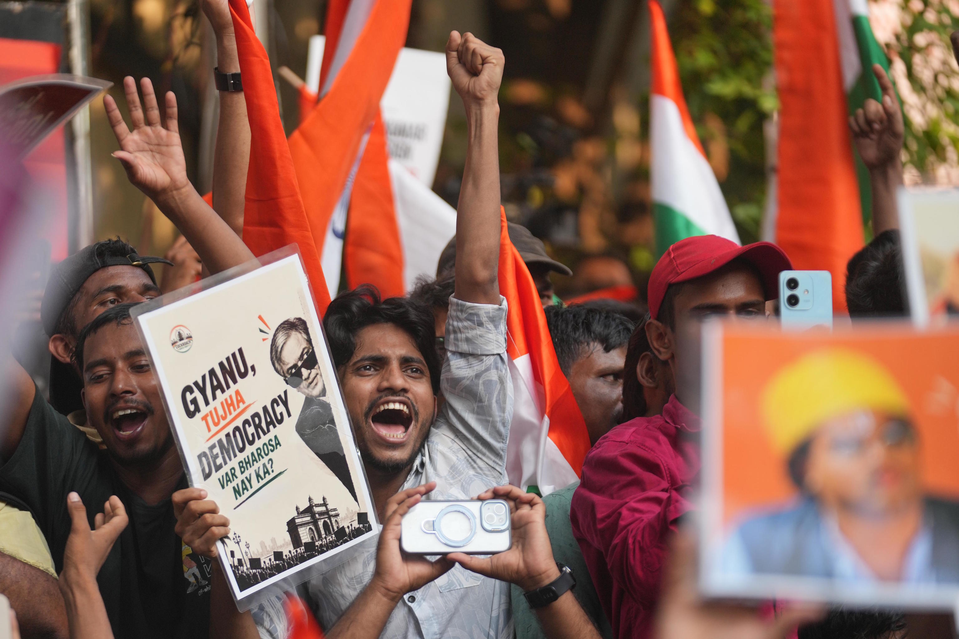 Supporters of the Cockroach Janta Party hold placards in a protest against Kumar.
