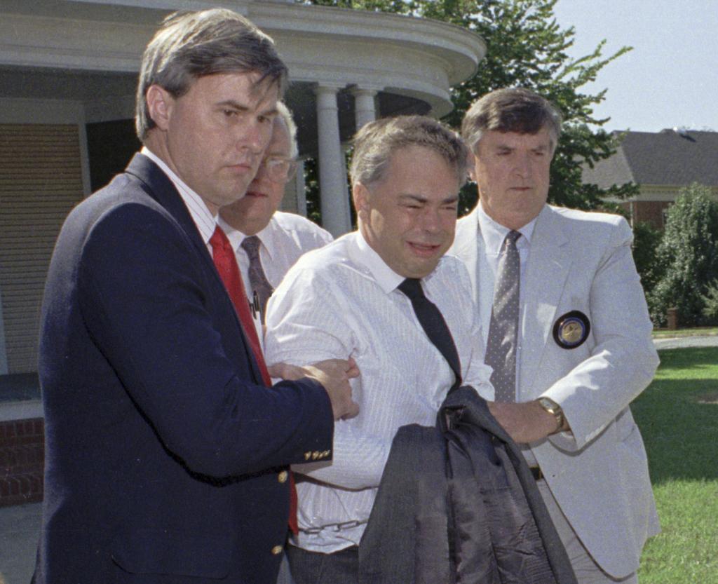 U.S. marshals escort former PTL leader Jim Bakker.